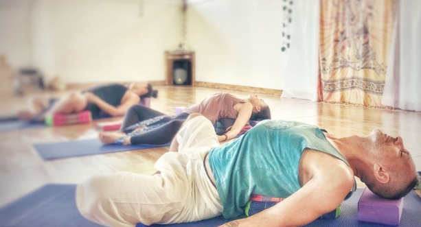 Realign & Renew Workshop participants practicing Yin yoga for healing and restoration in Decatur GA